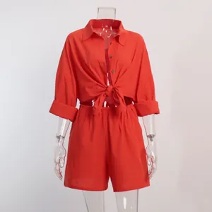 Close-up detail of a vibrant red tie-front shirt and matching casual shorts set