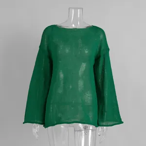 Detail of emerald green sheer open-knit sweater with elegant flared bell sleeves.