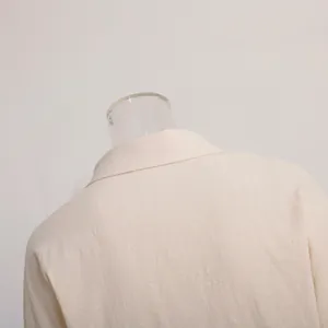 Close-up detail of beige linen blend shirt collar showing fabric texture