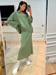 Full body detail of elegant olive green V-neck knitted sweater and maxi skirt set on model