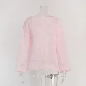 Detailed view of pink see-through hollow knit top featuring a round neck and flare sleeves