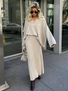 Sophisticated beige V-neck knitted sweater and maxi skirt set for a chic winter look
