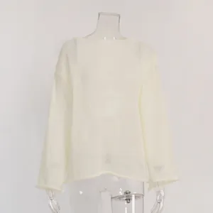 Detail view of white sheer hollow knit top featuring wide round neck and bell sleeves