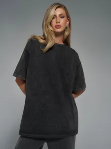 Detailed macro view of a washed black oversized t-shirt showing retro acid wash texture