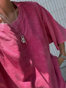 Detailed view of pink acid wash distressed T-shirt with vintage streetwear texture.