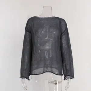 Close-up detail of grey sheer hollow knit sweater with elegant flared bell sleeves