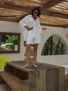 Elegant white linen two-piece resort set with oversized shirt and casual shorts