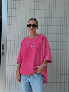 Oversized pink acid-washed T-shirt with vintage distressed texture and relaxed fit.