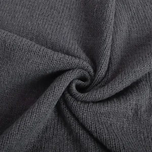 Macro detail of dark grey hollow knit fabric showing fine texture and soft weave