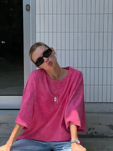 Detailed view of a washed pink oversized crew neck T-shirt with vintage texture