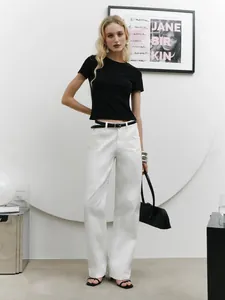 Minimalist black slim fit cropped short sleeve T-shirt paired with white high-waist jeans