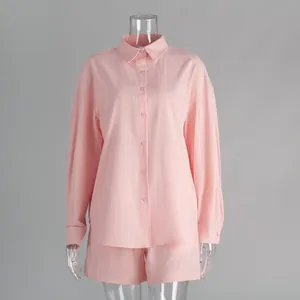 Macro detail of a pink cotton long-sleeve shirt and shorts casual set on mannequin