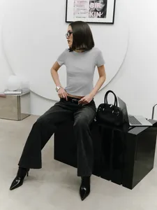 Trendy grey slim-fit crop t-shirt worn by a model in a minimalist studio setting