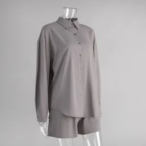 Detail of cotton long-sleeved shirt and shorts set in grey on a transparent mannequin.