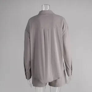 Rear view of a minimalist long-sleeved cotton shirt and shorts set in mauve purple.