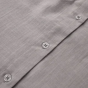 Detailed macro shot of grey pure cotton cardigan fabric featuring buttons and stitching