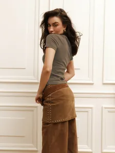 Slim fit taupe short sleeve crop t-shirt shown from back view on a model posing.