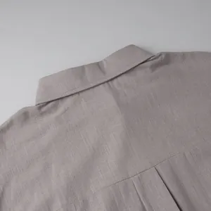 Close-up of a minimalist pure cotton shirt collar showing detailed fabric texture and stitching