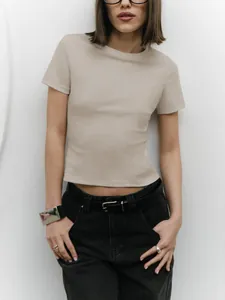 Detailed view of minimalist beige short sleeve cropped t-shirt for women, slim fit style