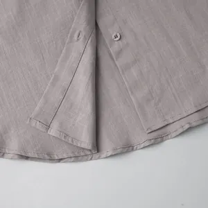 Detailed close-up showing the fine fabric texture and button placket of a cotton shirt