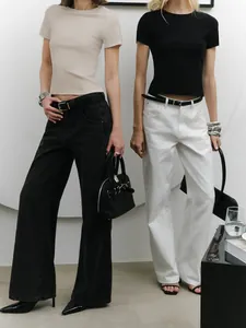 Minimalist slim fit crop top t-shirts in beige and black colors worn by two fashion models