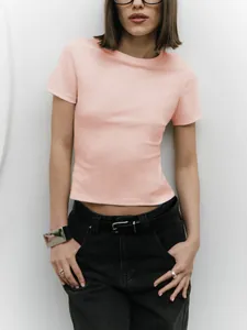 Close-up of a slim-fit peach colored crop top T-shirt for a modern minimalist style look
