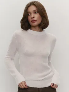 Detailed view of a white semi-sheer mohair crew neck sweater with soft knit texture