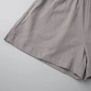 Detailed macro shot showing the fine stitching and linen-like texture of grey casual shorts