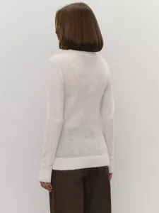Back view of a white semi-sheer mohair knit sweater showing delicate texture