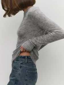 Detail view showing the soft mohair texture and semi-sheer knit of the gray sweater
