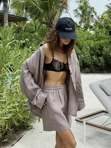 Detail of minimalist mauve cotton linen shirt and shorts set for a summer resort look