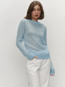 Detail of light blue semi-transparent mohair sweater with crew neck for women.