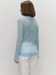 Back view of a light blue semi-sheer mohair sweater showing soft knitted texture.