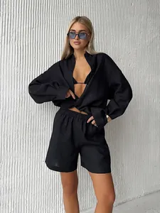 Detailed view of women's black cotton long-sleeve shirt and matching shorts casual set