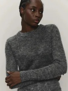 Detail view of premium grey mohair knit sweater texture and comfortable crew neck fit