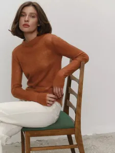Detailed view of rust-orange mohair sweater featuring a soft semi-sheer knit texture.