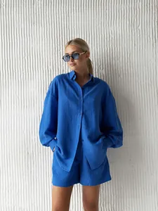 Blue long-sleeved shirt and shorts set shown on a model for a relaxed fit look.
