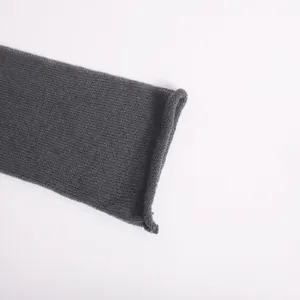 Close-up of charcoal grey sheer mesh knit texture and delicate flared sleeve cuff detail