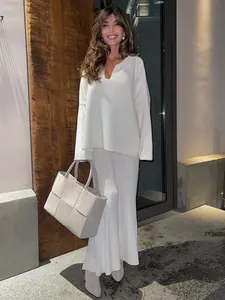 Elegant white V-neck knitted sweater and long skirt set for chic winter fashion