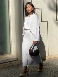 Elegant white V-neck knit sweater and midi skirt set for women in minimalist winter style