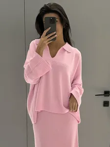 Fashionable pink V-neck knit sweater and matching ribbed maxi skirt two-piece set