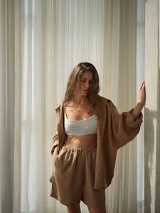 Detailed view of women's brown linen shirt and shorts set for casual summer resort wear