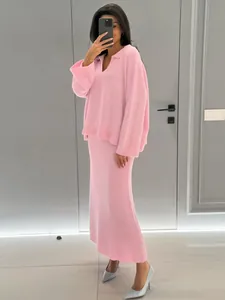 Elegant pink two-piece knit set featuring a cozy V-neck sweater and matching long skirt.