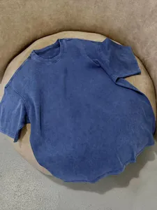 Detailed view of vintage washed blue T-shirt with heavy cotton texture and relaxed fit