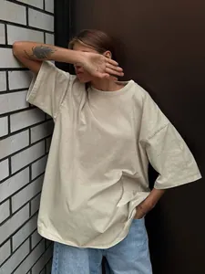 Detailed view of an oversized washed beige t-shirt featuring a soft brushed texture