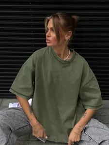 Lifestyle detail of relaxed fit washed olive green T-shirt with vintage distressed texture