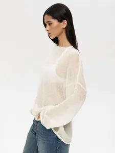 Profile view of a white sheer knit sweater with bell sleeves and loose fit design.