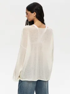 Back view detail of a sheer off-white hollow-out knit sweater featuring a loose casual fit