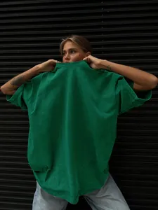 Detailed view of the washed green oversized T-shirt with a vintage distressed finish.
