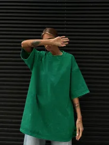 Detailed view of oversized washed green t-shirt with distressed vintage finish